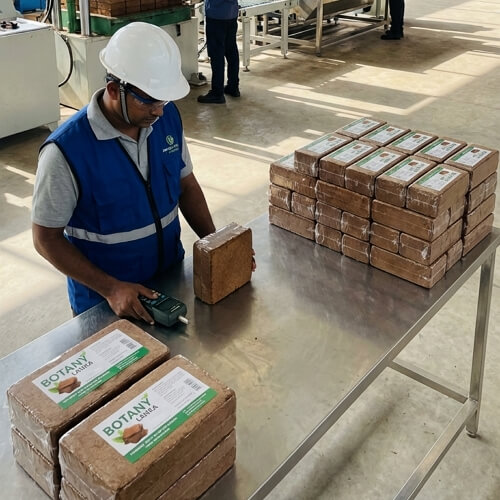 Man operating coco coir machine